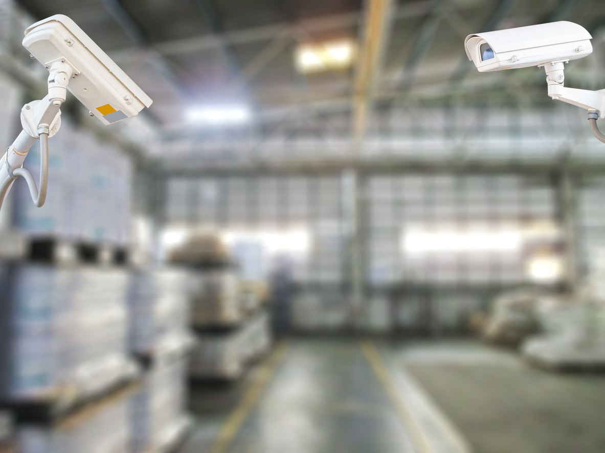 two warehouse security cameras with background out of focus