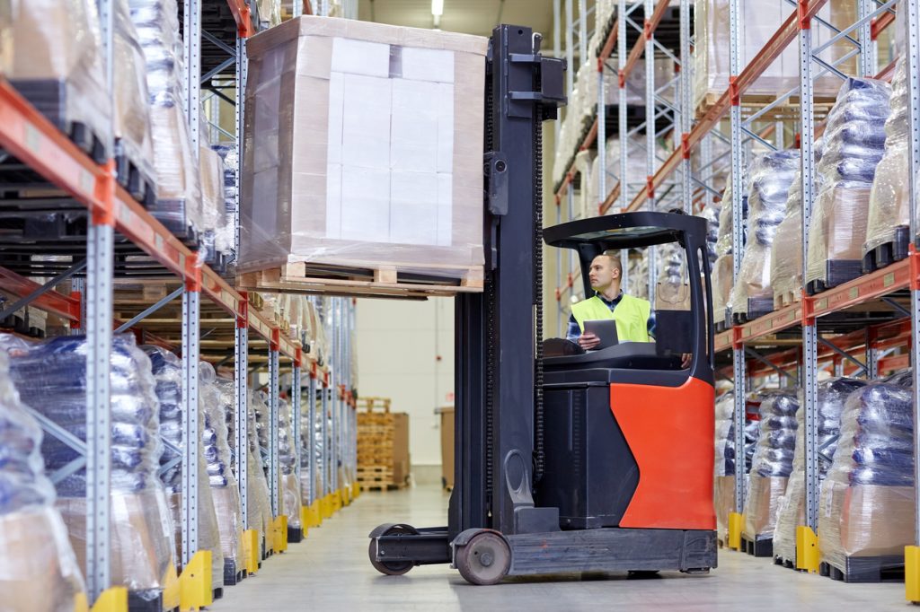 man operating forklift in warehouse