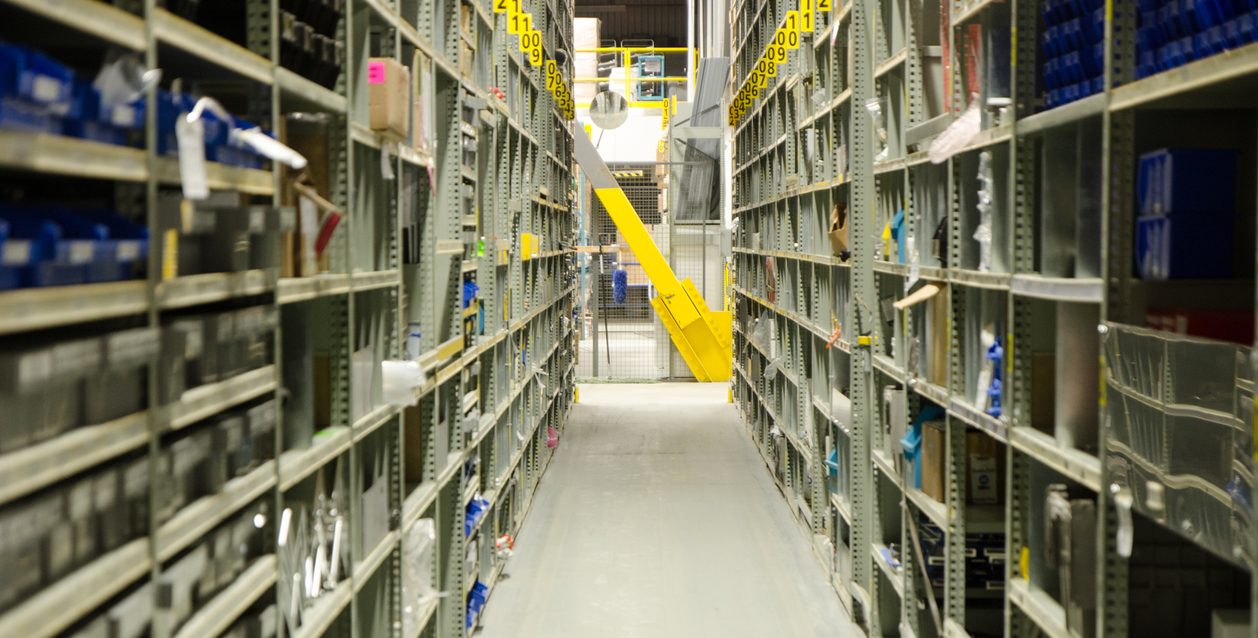 warehouse aisle with industrial steel shelving