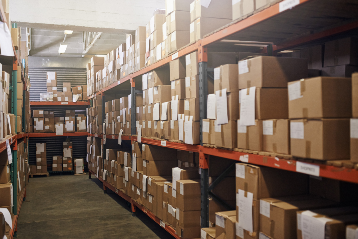 A packed warehouse in need of storage solutions 