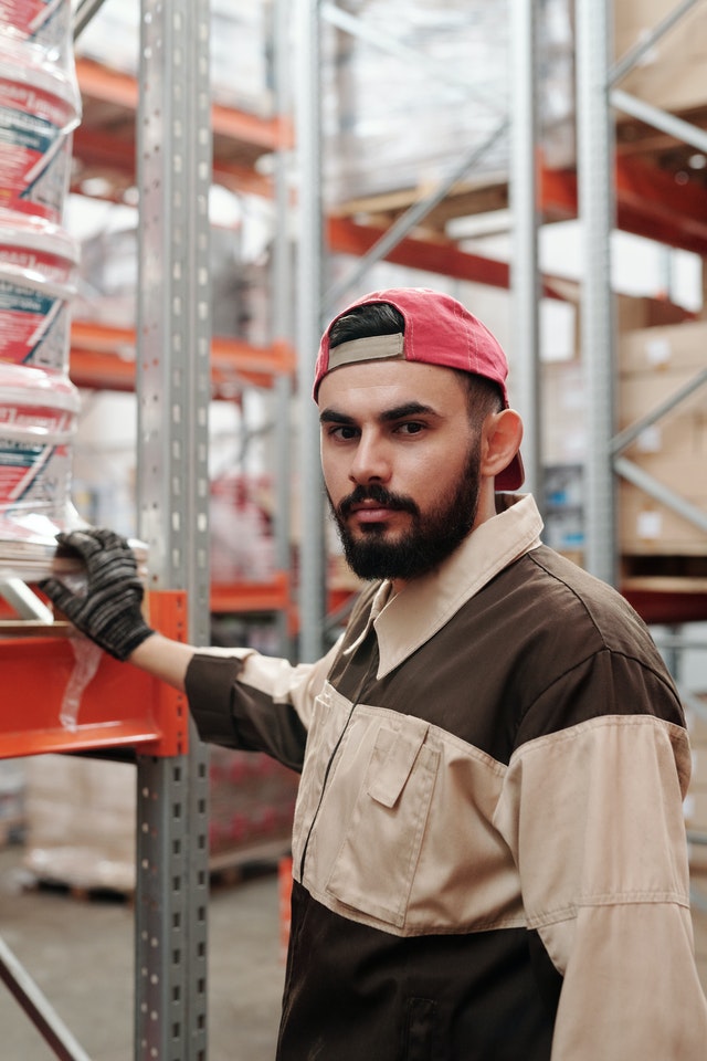 warehouse worker preparing for pallet racking safety inspection